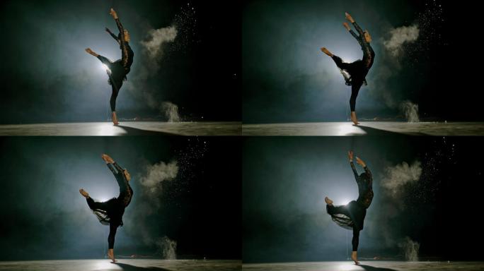 超级SLO MO专业芭蕾舞演员在舞台上旋转时将手上的灰尘扔掉