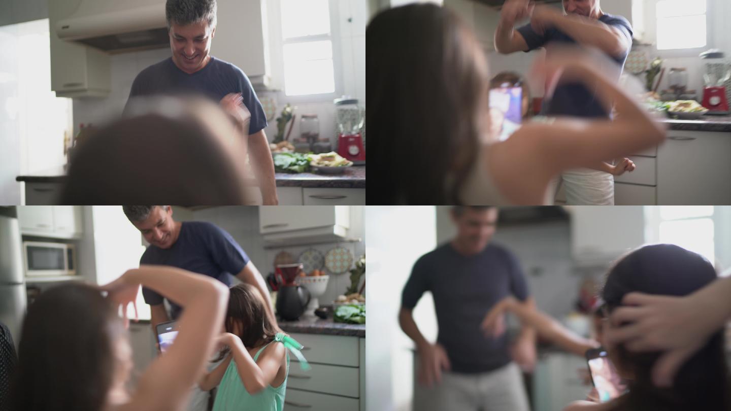 爸爸和女儿在厨房边跳舞边拍电影