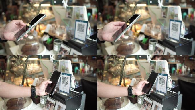 亚洲顾客在咖啡馆的柜台酒吧使用手机非接触支付。