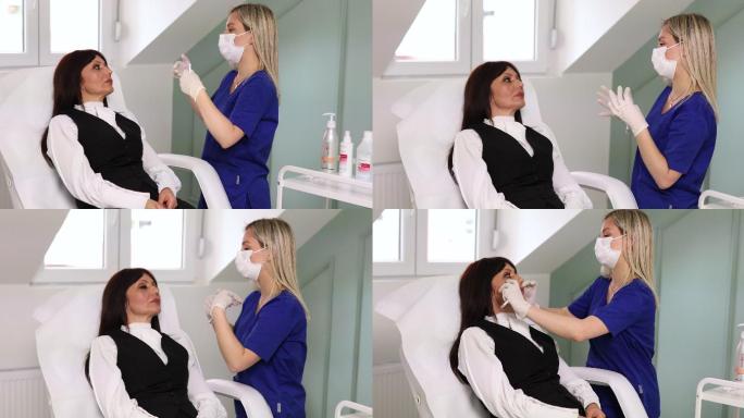 专业的女性美容师，观察客户的面部，尤其是脸颊区域，以便在开始治疗前了解情况