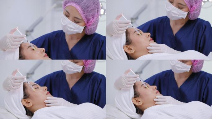 美丽的亚洲年轻女子正在美容诊所接受面部注射，使其焕发青春。专家美容师正在用A型肉毒毒素填充女性皱纹。
