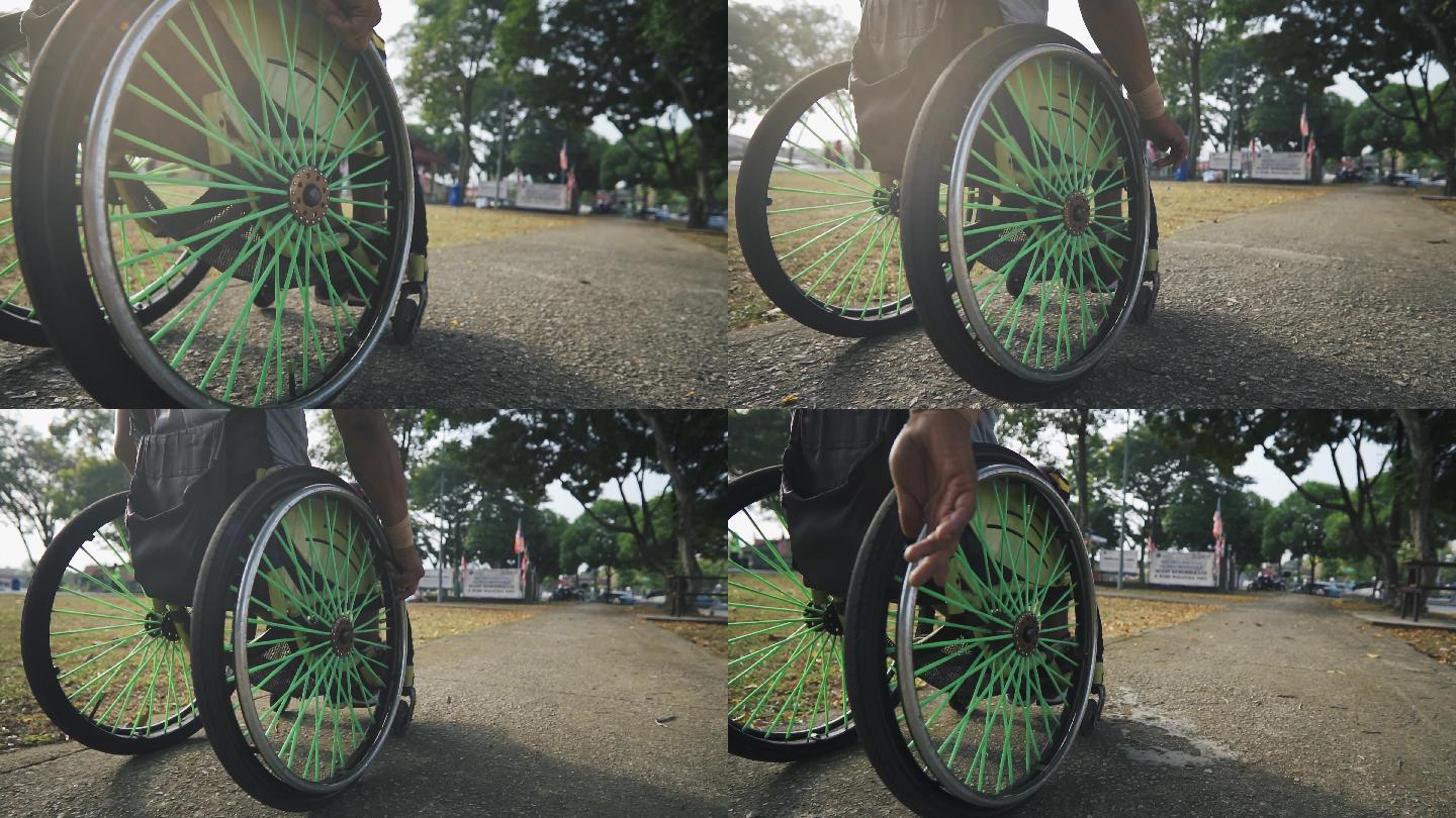 低角度残疾的亚裔印度男子坐轮椅在公园锻炼，早上进行常规运动训练