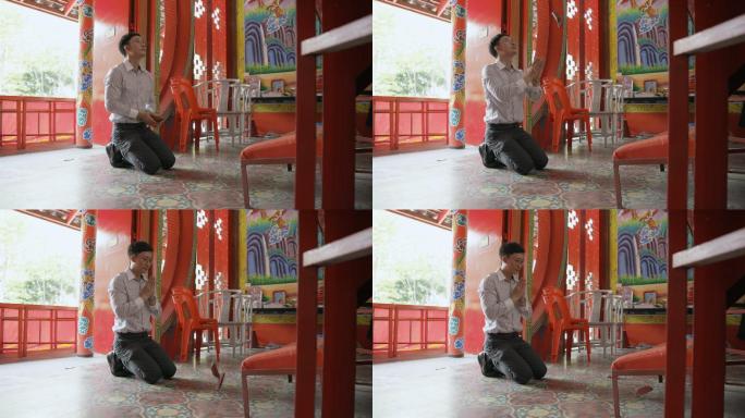 慢镜头亚裔男子在寺庙求签