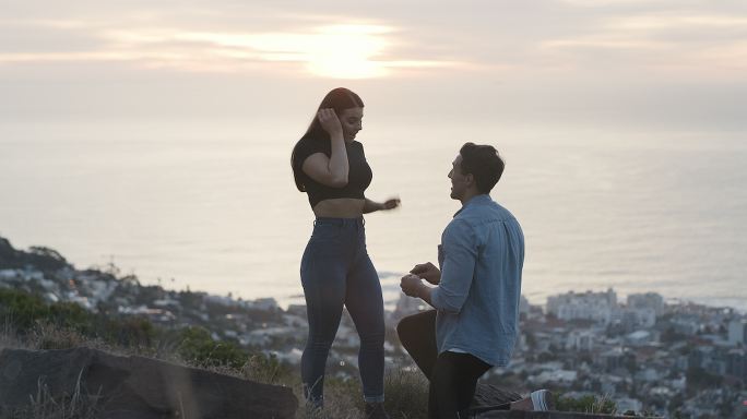 一名男子在俯瞰城市的悬崖上向女友求婚的4k视频片段