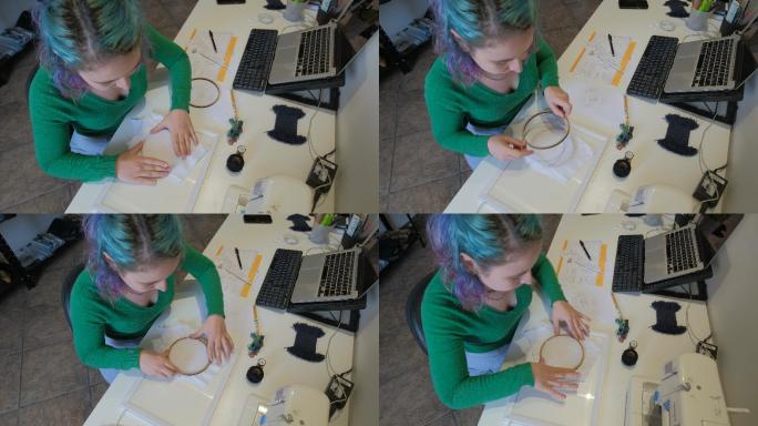 年轻女子正在准备刺绣箍的设计