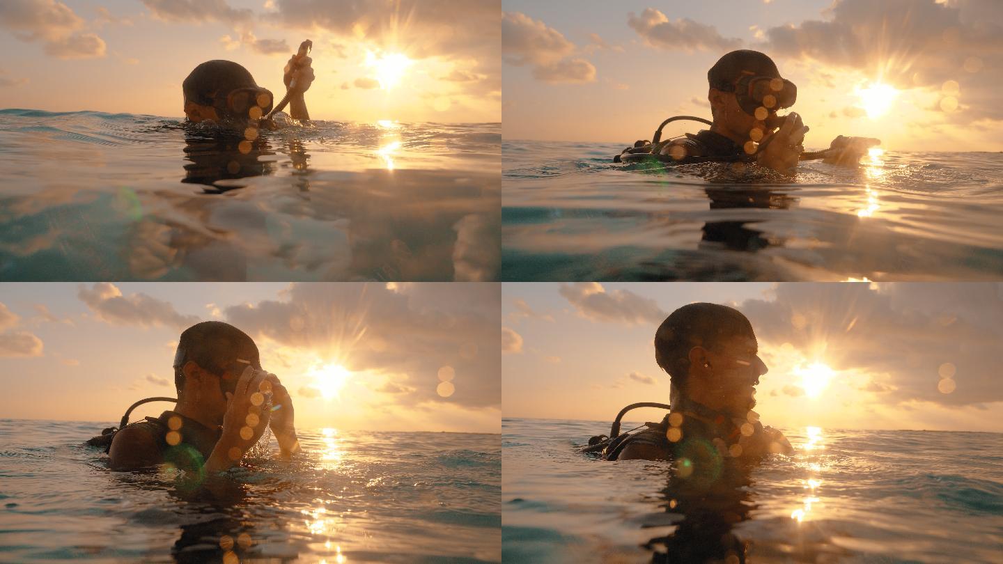 一名戴水肺的潜水员在日落时从水中浮出水面的特写镜头
