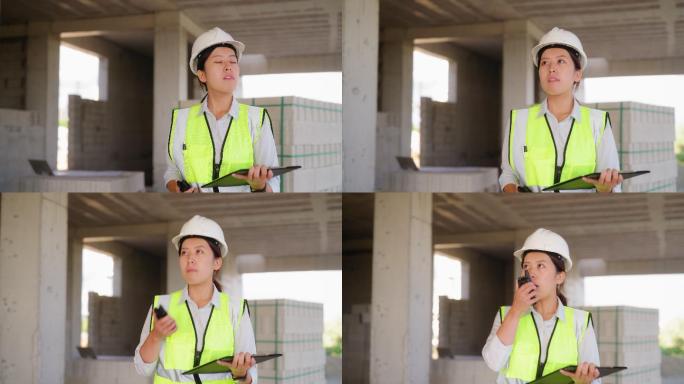 年轻女工程师在施工现场使用对讲机