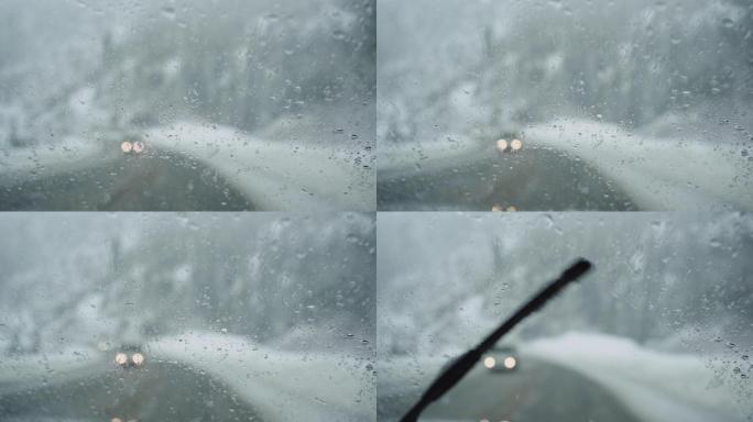 雪落在高速公路上行驶的汽车挡风玻璃上
