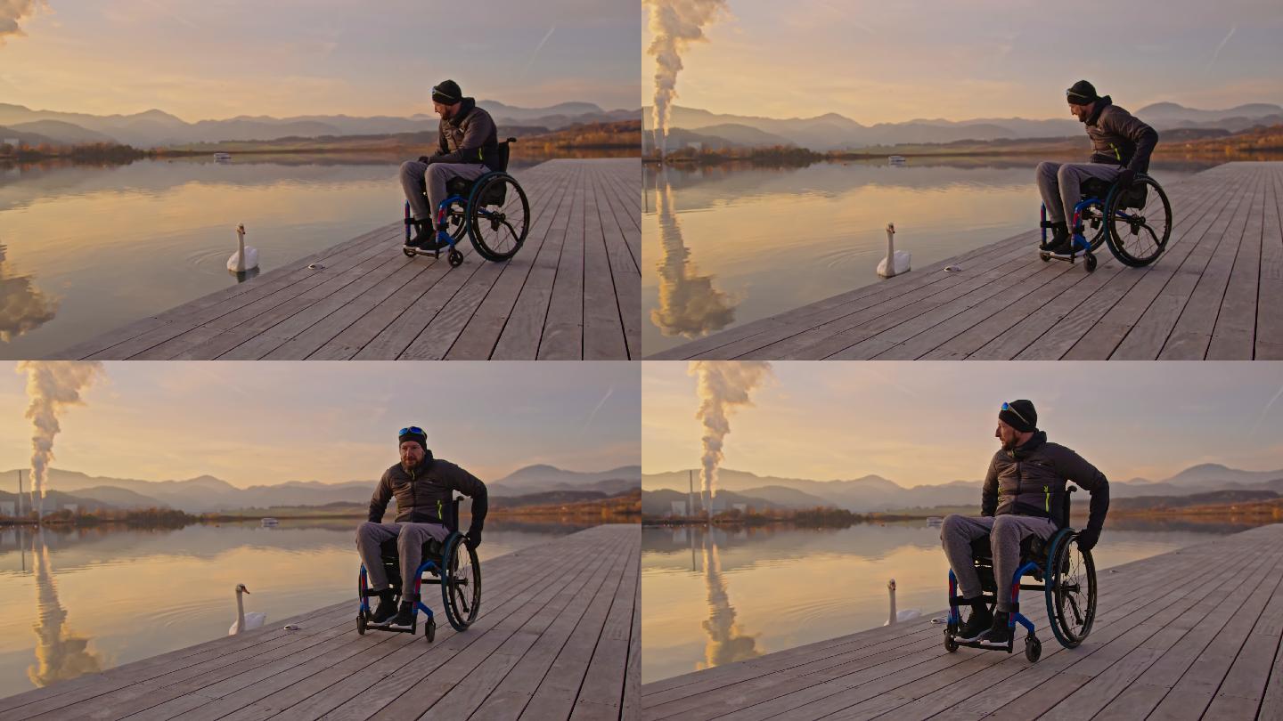 坐在轮椅上看着湖面上漂浮的天鹅的成熟男人