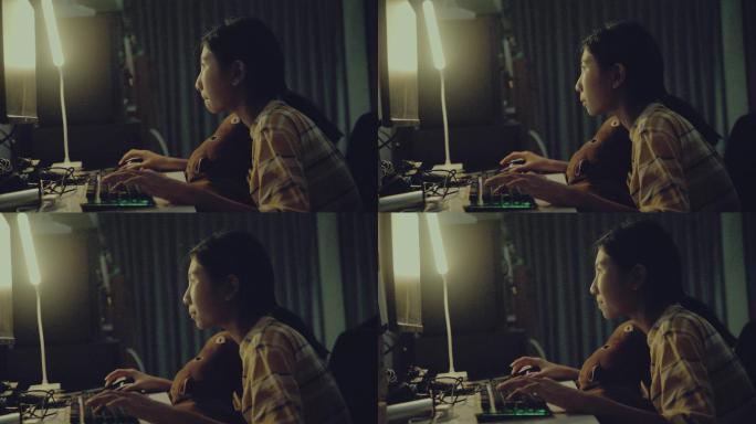 亚洲女孩晚上在家用Pc电脑玩网络游戏，生活方式理念。