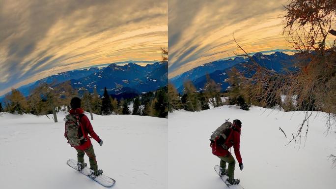 垂直视频POV拍摄的两名自由式滑雪板运动员在山下的树木之间雕刻