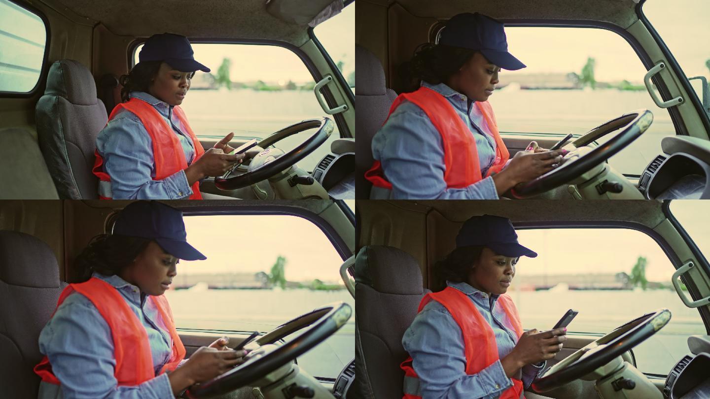 黑人女卡车司机在驾驶室检查智能手机