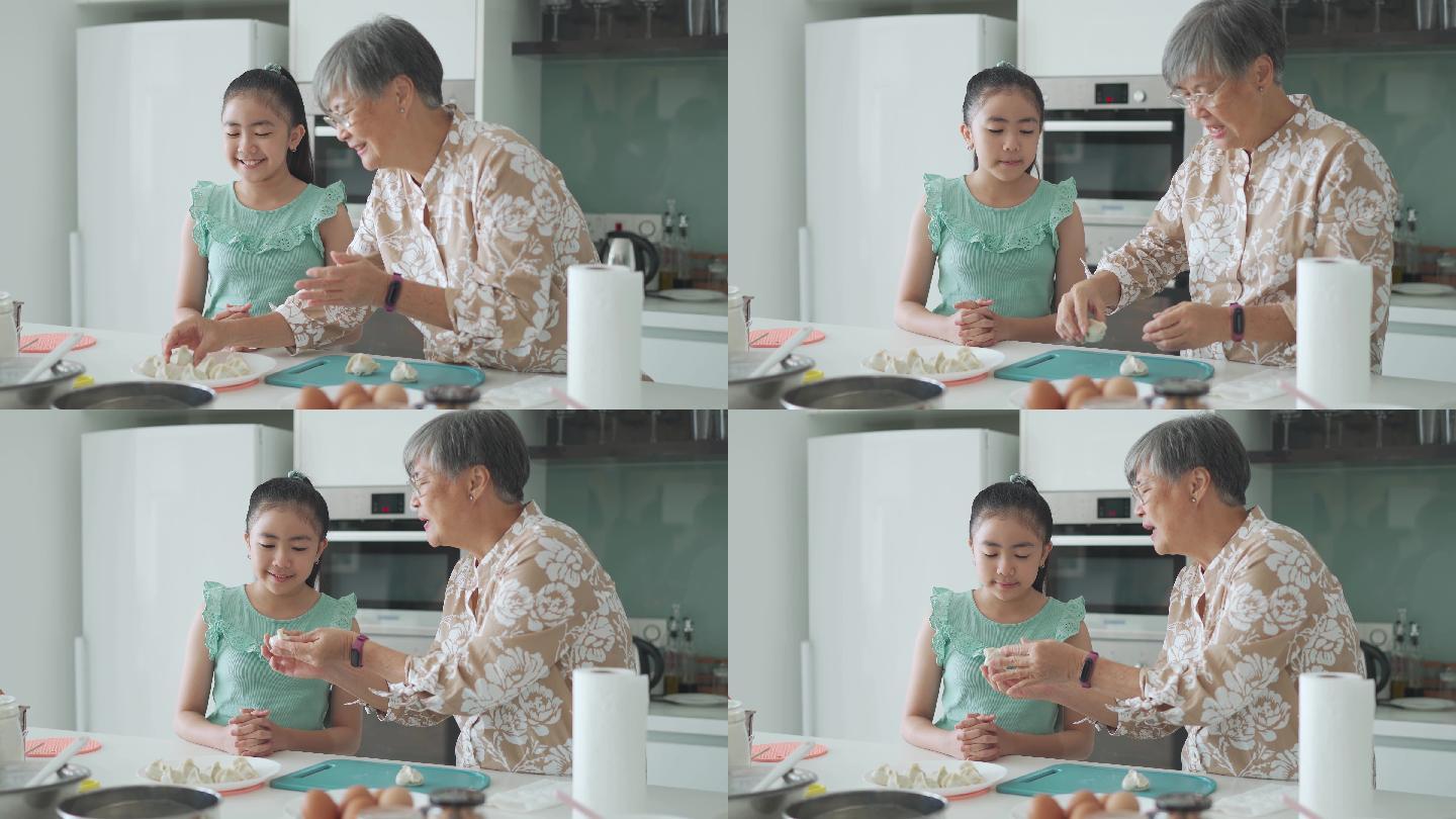 周末闲暇时间，亚裔中国小女孩在厨房向祖母学习做饺子