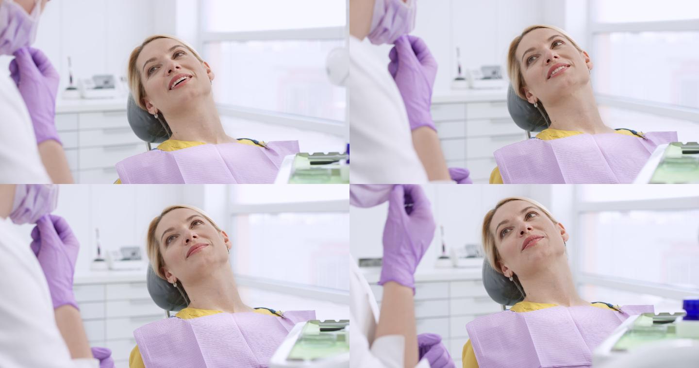 女患者坐在牙科手术椅上，与牙医交谈
