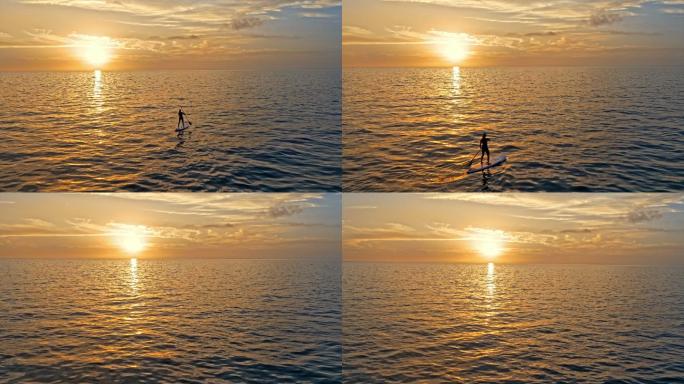 当太阳落山时，一个在海上仰面划水的空中人