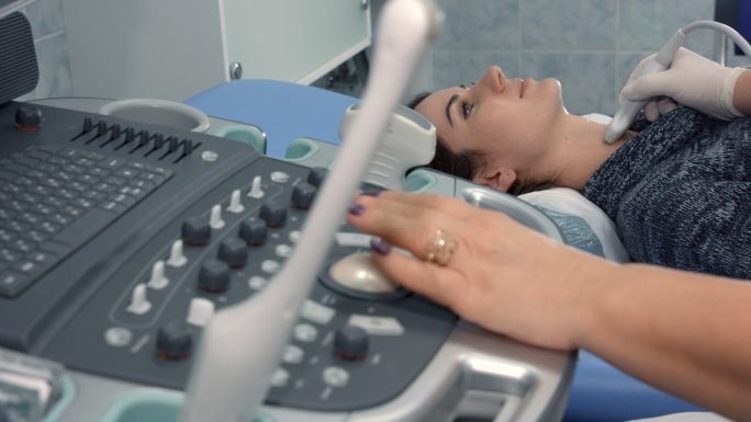 女性患者在医院接受甲状腺超声检查