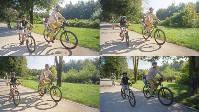 一名男子和他的家人在阳光明媚的公园里骑自行车，他蹒跚学步的儿子坐在自行车后座上
