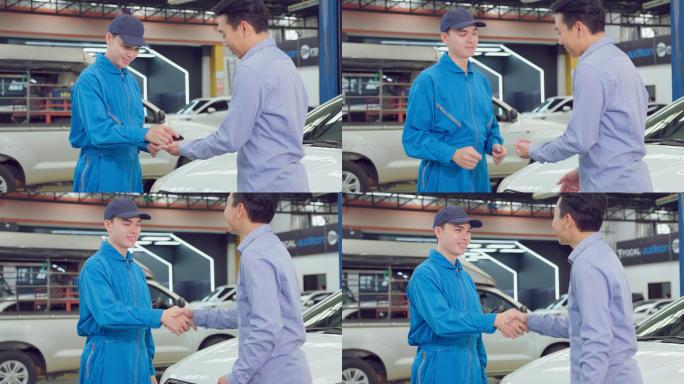 汽车修理工在车库与客户握手