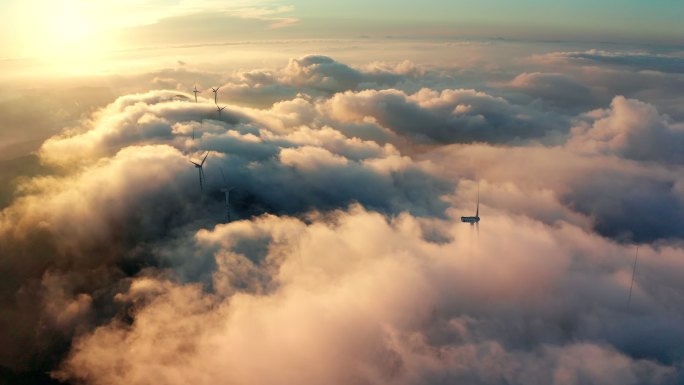航拍大气磅礴风力发电转动风车山云海日出