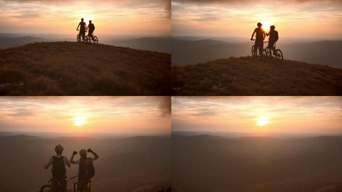 日落时山顶上的山地自行车骑手天线