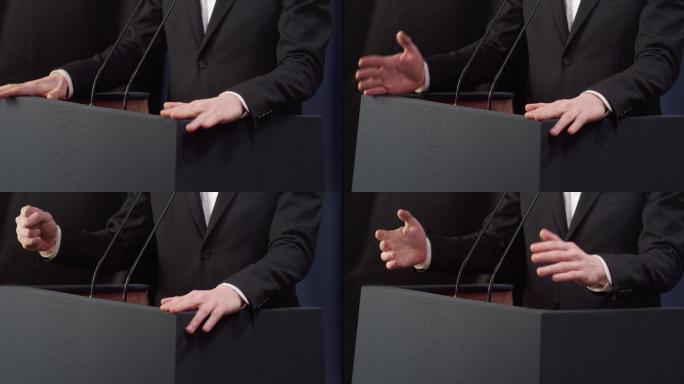 特写镜头：一位情绪激动的政客在政治集会上发表演讲时，用暴力做手势