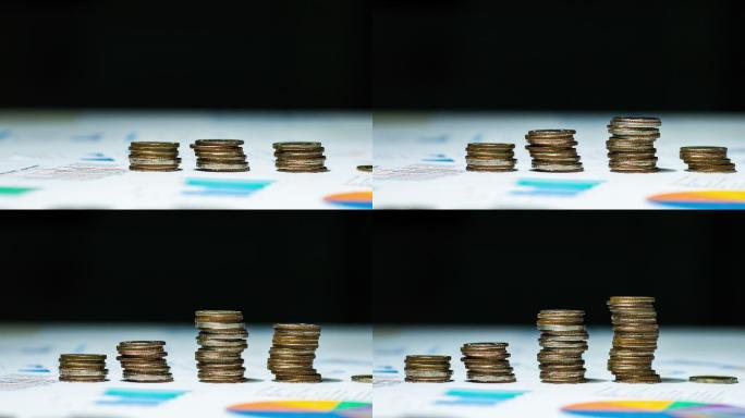 多利拍摄的将硬币堆积在财务文件上的延时视频。