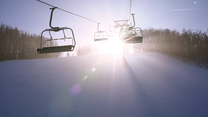 4K阳光照射在滑雪升降椅后面，在雾中沿着电线移动，实时