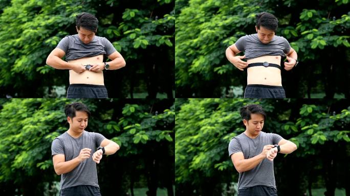 亚裔男子戴着心率带，然后按智能手表跑步