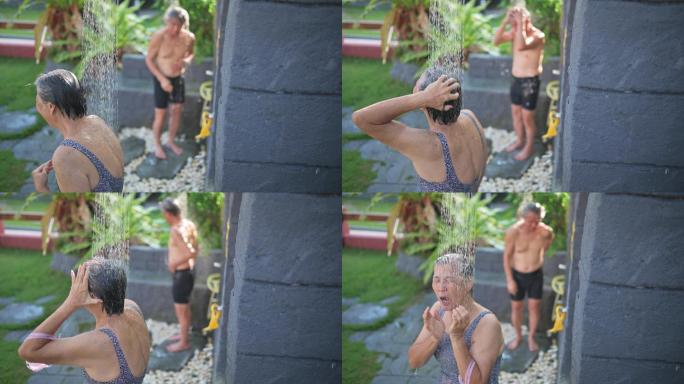 亚裔华裔高年级夫妇在进入游泳池上课前洗澡