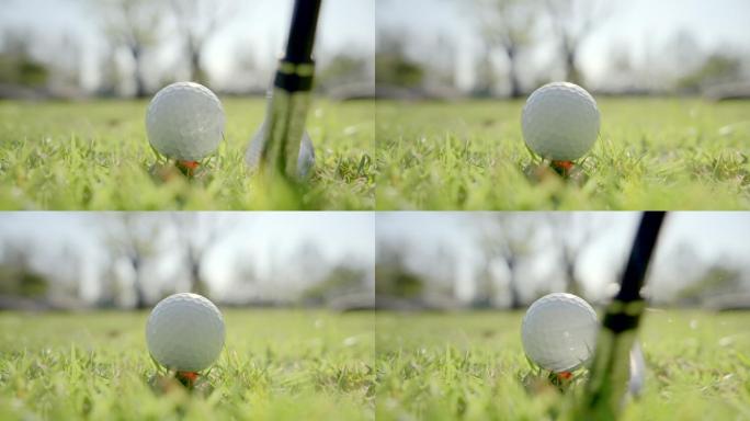 特写镜头：早上在美丽的高尔夫球场上打高尔夫的高尔夫球手，以慢动作挥杆击球。在高尔夫球的击球中，球从发