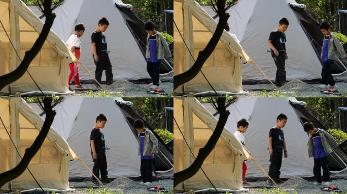 小孩在帐篷边玩耍露营
