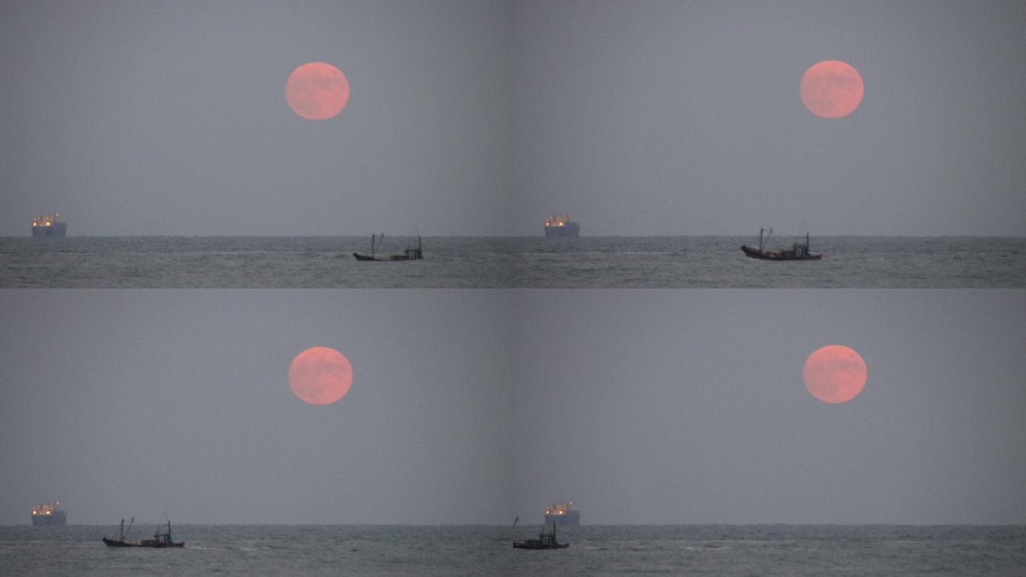 大海上初升的明月和一条渔船