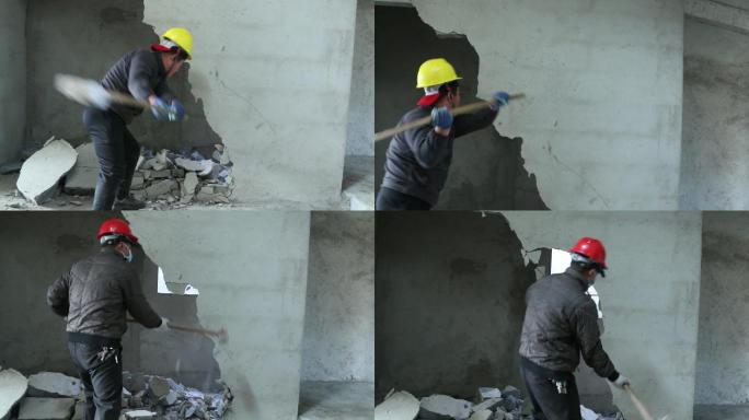 男子工人挥舞大锤击碎拆除建筑墙壁