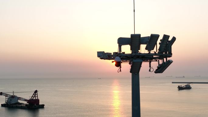 海边落日下5G基站5G摄像头5G铁塔