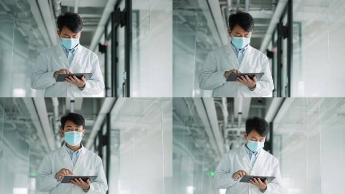 年轻医学科研人员使用平板电脑进行工作