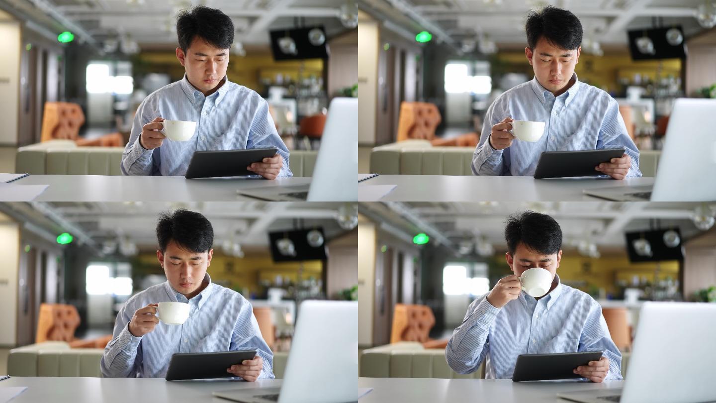 年轻商务人士在办公室咖啡时间使用平板电脑