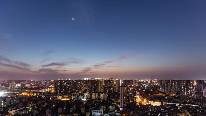 城市日转夜白天到黑夜万家灯火延时月亮落下