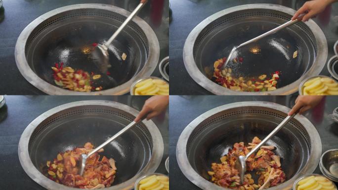 一间农家乐餐厅用烧柴土锅制作辣椒炒土鸡
