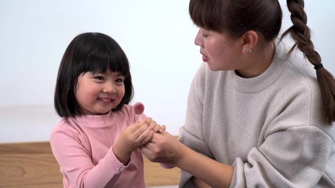 接过母亲手里棒棒糖的女孩