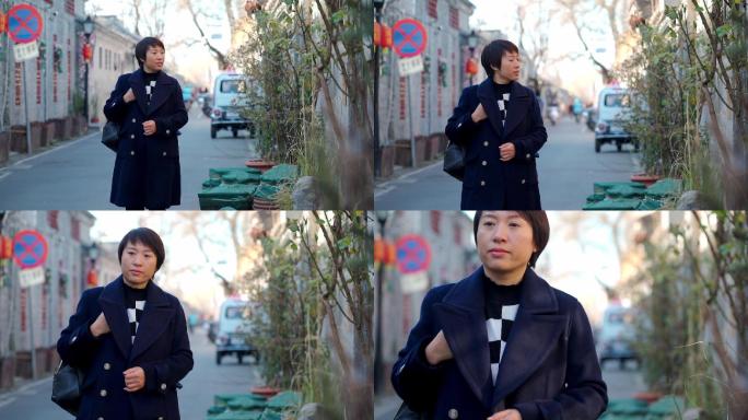 冬季走在北京古老胡同的东方女性