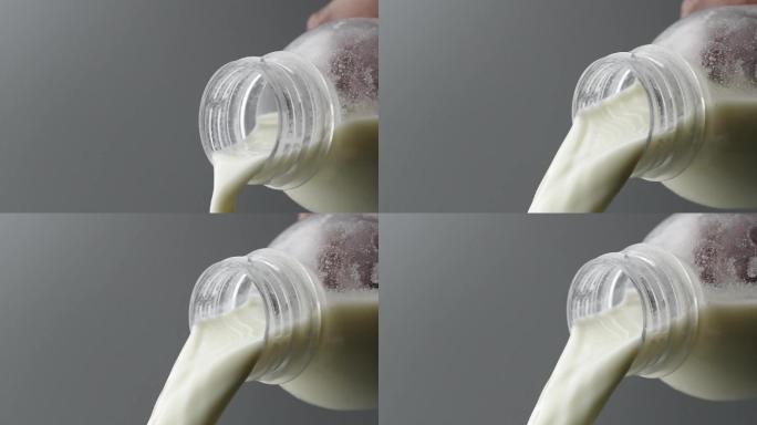 慢镜头拍摄瓶口倾倒中的牛奶