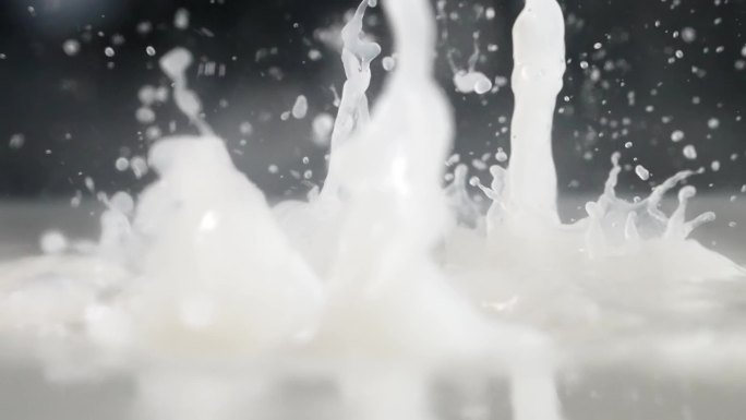 慢镜头拍摄有机花生米落入牛奶创意视频
