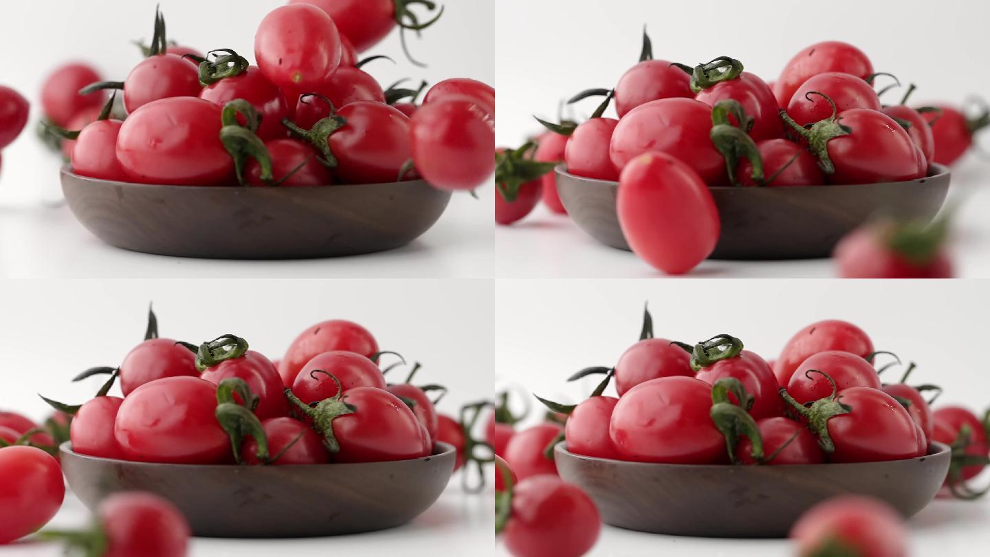 慢镜头拍摄落到碗中新鲜有机小番茄
