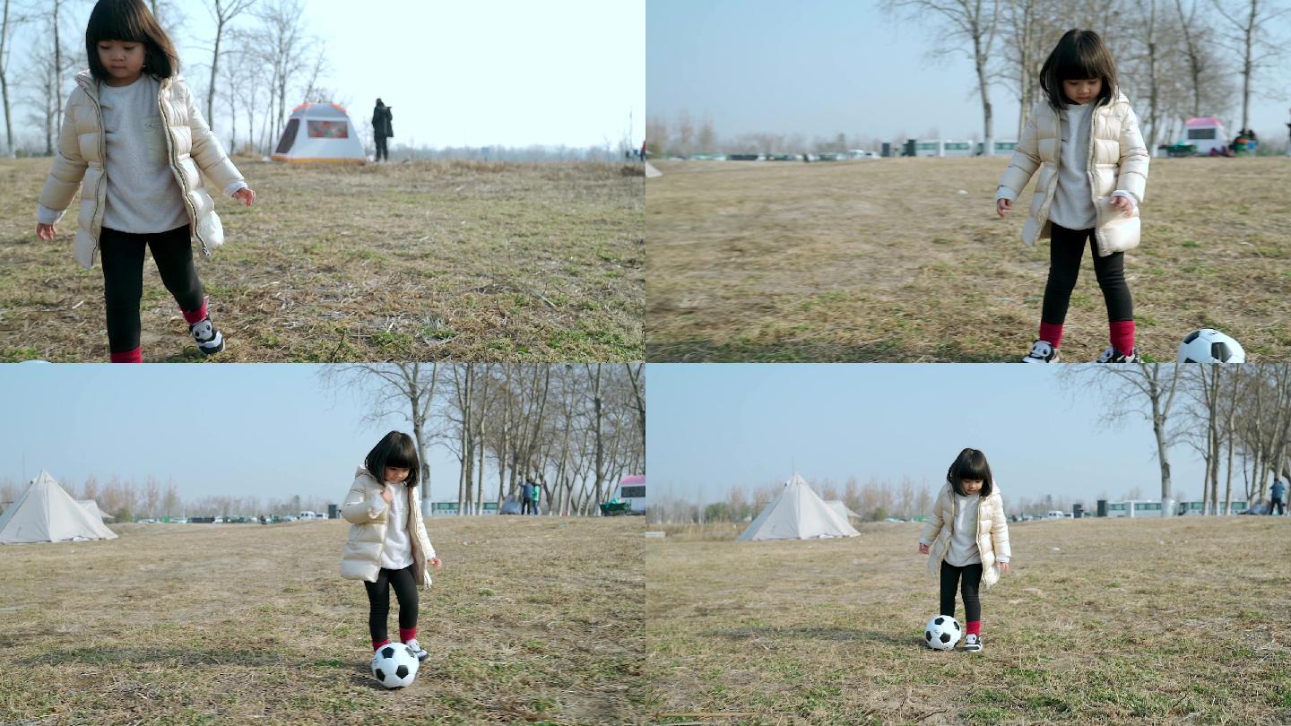 冬季在公园草坪上踢球的女孩