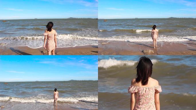 年轻美女行走在厦门大海边沙滩上