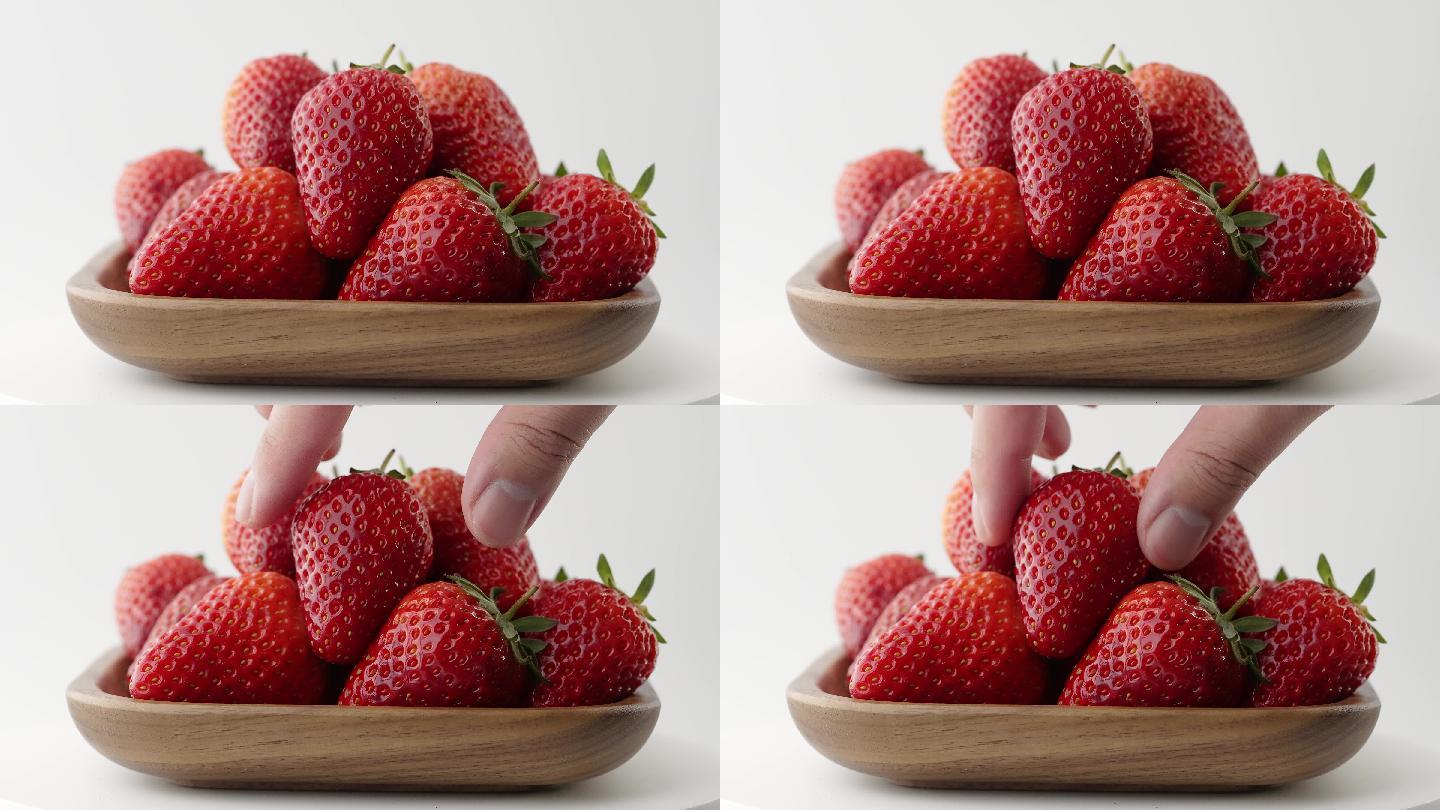 择取碗中新鲜爆浆草莓