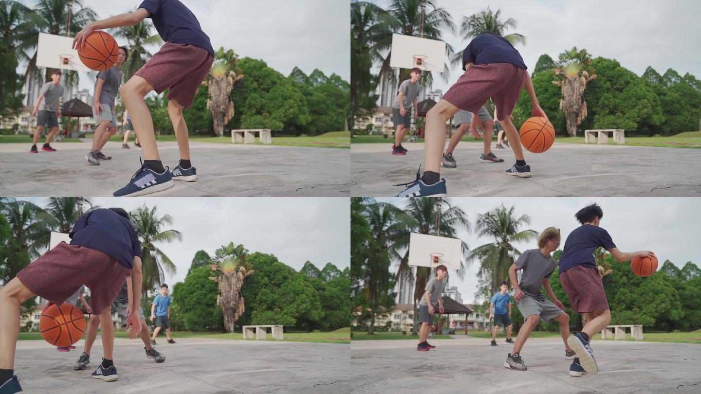 慢动作Z一代亚裔中国少年在周末早上和朋友练习篮球比赛时挑战球员并投篮