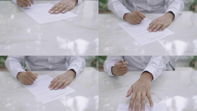 汽车经销商签署协议书，然后将文件滑到相机上