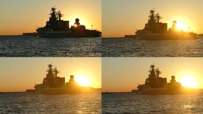 军舰的轮廓和日落时的太阳