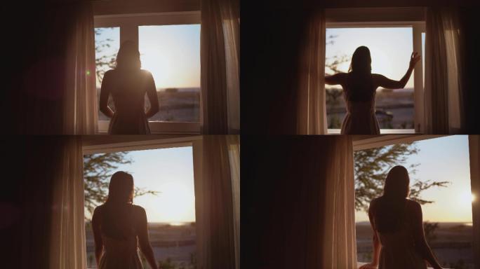 年轻女子透过酒店的窗户